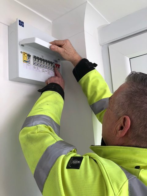 An electrician checking fuse board - Ashford Kent