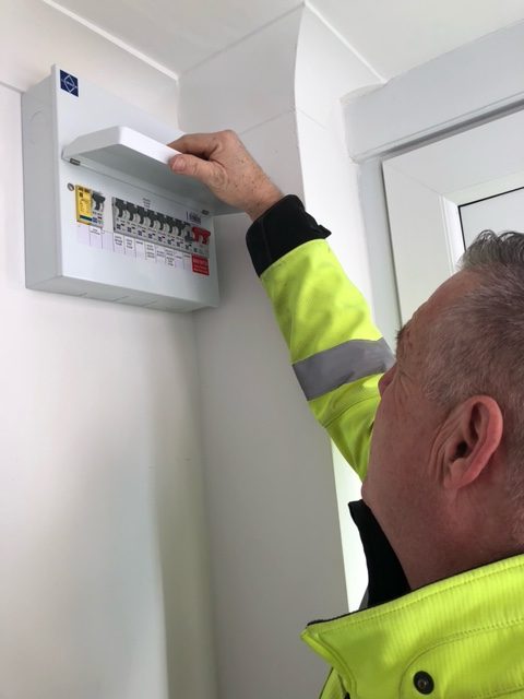 electrician checking a fuse board